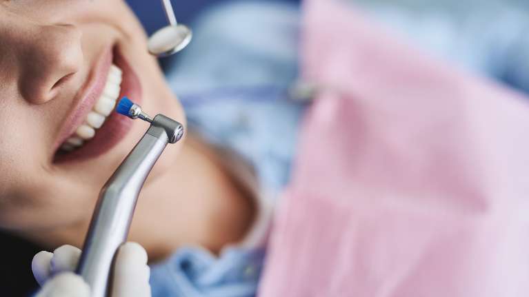A woman receiving a dental cleaning in Columbus