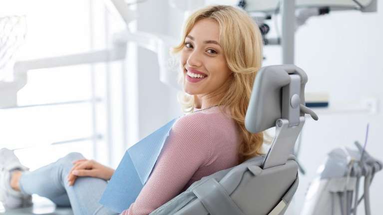 Blonde woman smiling in dental chair, clintonville ohio