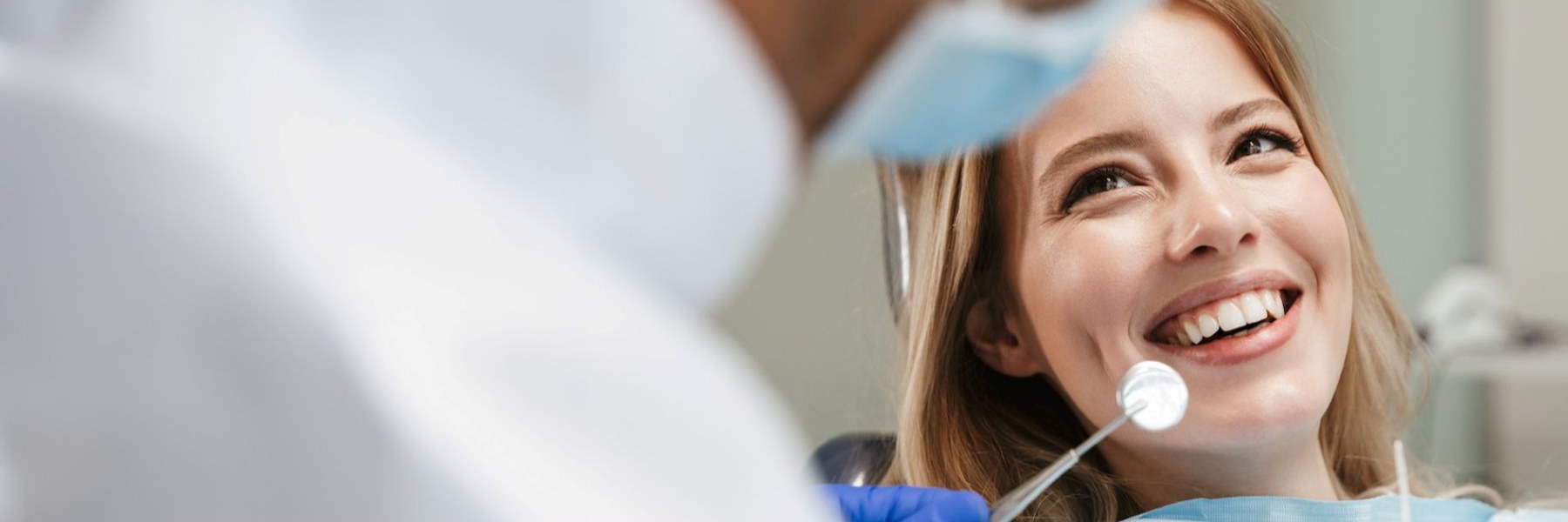 Red hair woman smiling in dental chair, clintonville ohio