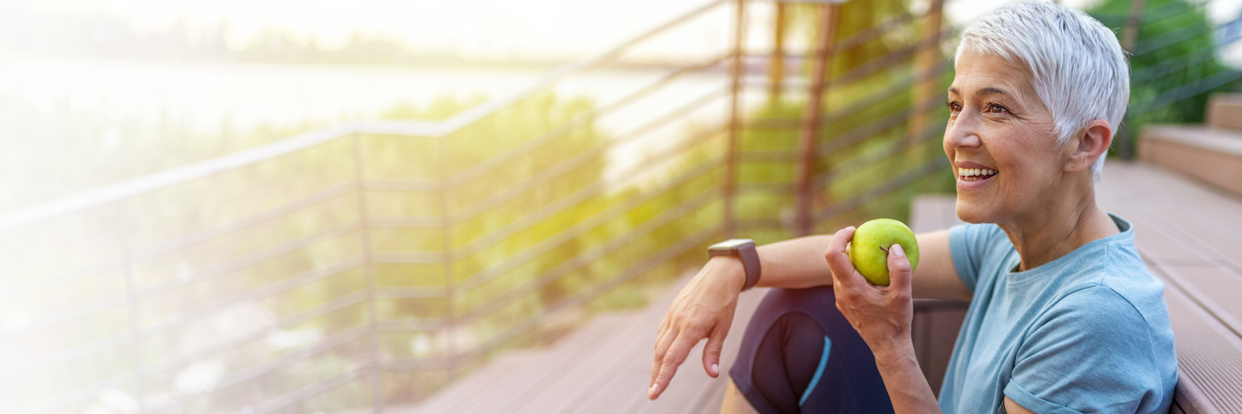 woman with blue background smiling l dental implants columbus oh